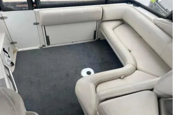 Slide: The Image of 2001 Regal Commodore 2960 boat interior with beige seating and carpeted floor. - 2