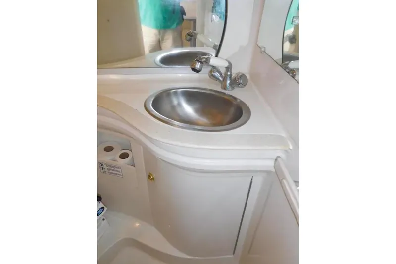 Slide: The Image of 2001 Regal Commodore 2960 boat bathroom sink with mirror and storage cabinet. - 20