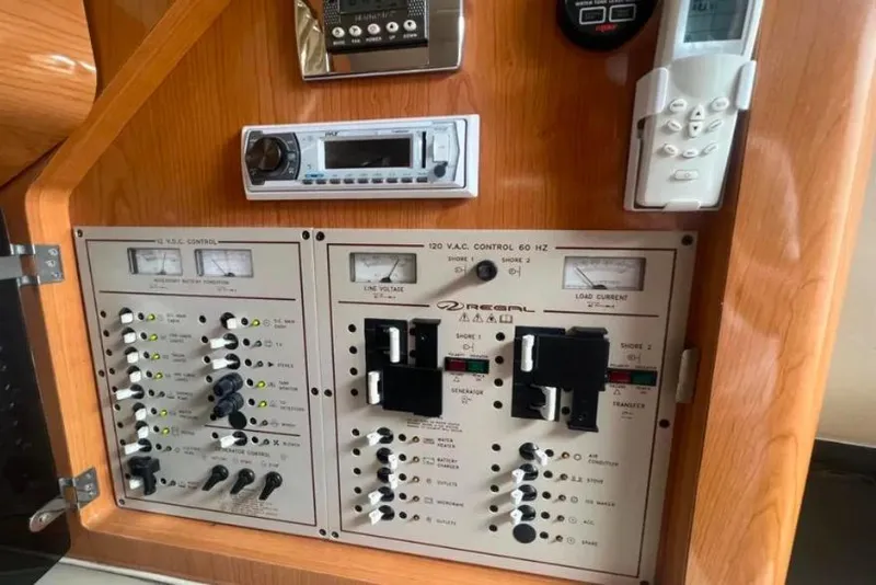 Slide: The Image of Control panel of a 2001 Regal Commodore 2960 boat with various switches and meters. - 6
