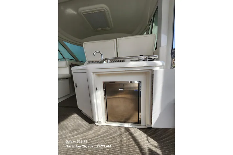 Slide: The Image of 2004 Sea Ray 390 Motor Yacht interior with wet bar and new stainless steel fridge. - 11