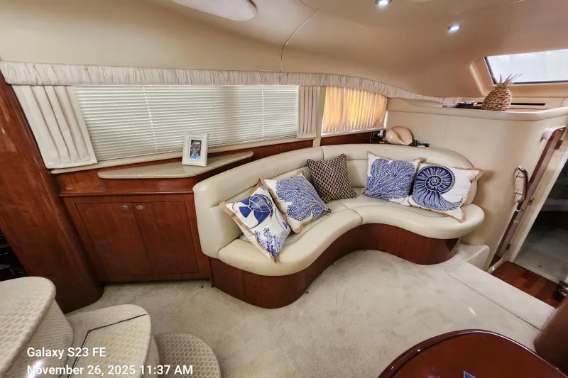 Slide: The Image of Luxurious 2004 Sea Ray 390 Motor Yacht interior with elegant seating and decorative pillows. - 14