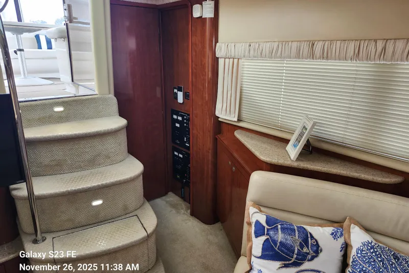 Slide: The Image of Interior of 2004 Sea Ray 390 Motor Yacht with carpeted stairs and cozy seating area. - 15