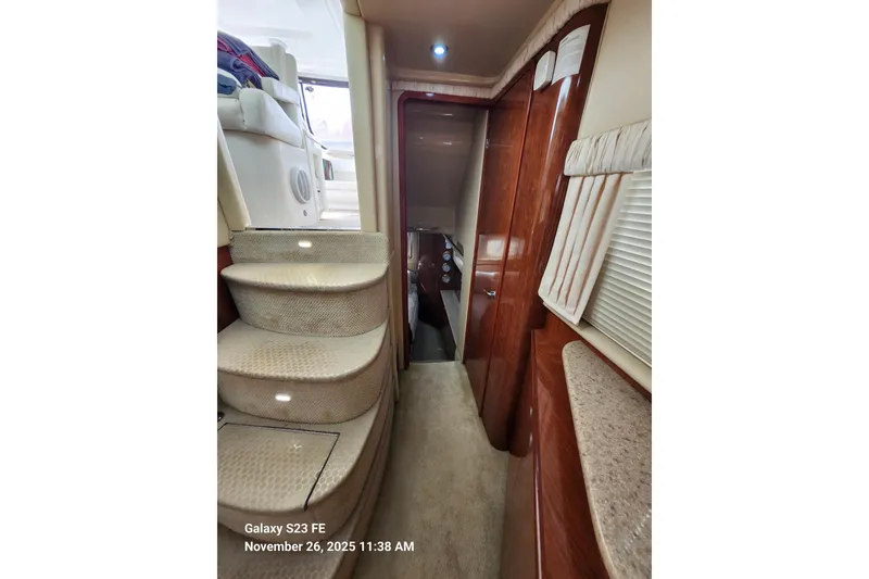 Slide: The Image of Interior of 2004 Sea Ray 390 Motor Yacht with carpeted stairs and wood paneling. - 17