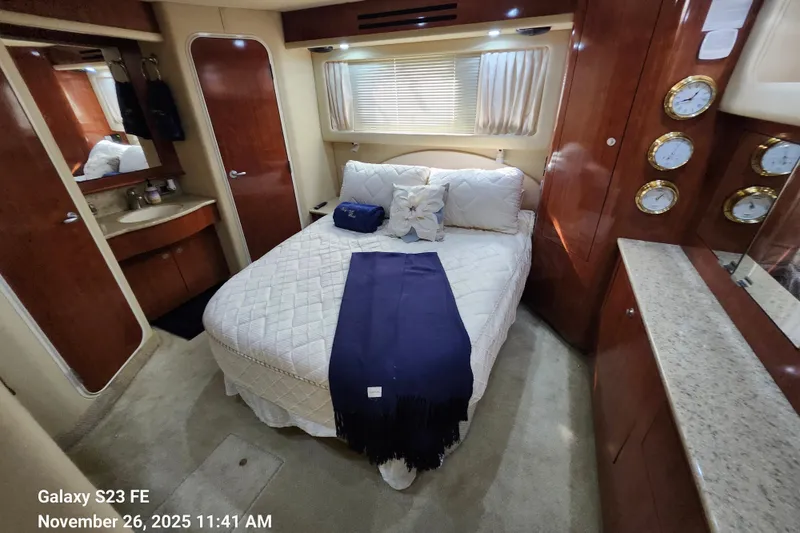 Slide: The Image of Luxurious 2004 Sea Ray 390 Motor Yacht bedroom with elegant wood finishes and cozy bedding. - 18