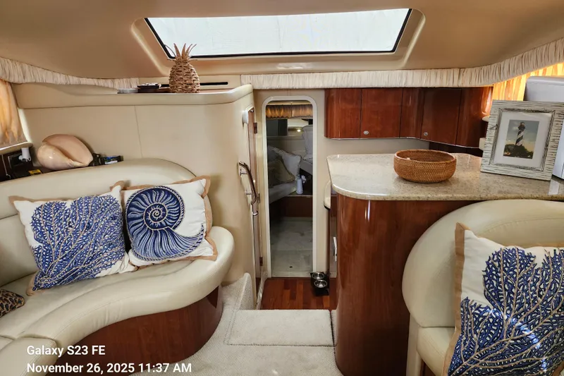 Slide: The Image of Interior of 2004 Sea Ray 390 Motor Yacht with elegant decor and nautical-themed cushions. - 25