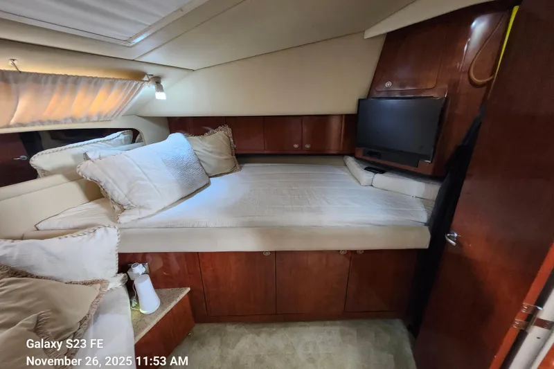 Slide: The Image of Cozy bedroom in 2004 Sea Ray 390 Motor Yacht with TV and plush bedding. - 27