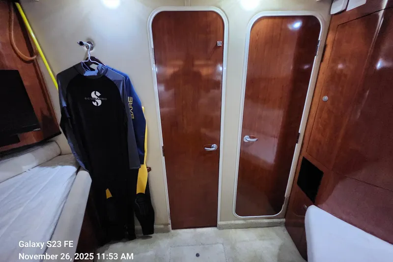 Slide: The Image of Interior of 2004 Sea Ray 390 Motor Yacht with wetsuit and wooden doors. - 29