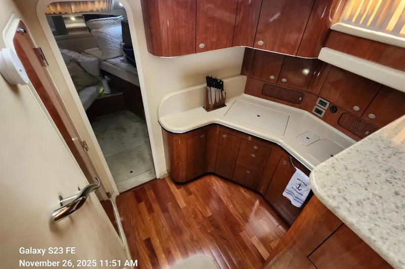 Slide: The Image of 2004 Sea Ray 390 Motor Yacht galley area and entry door to guest cabin. - 34
