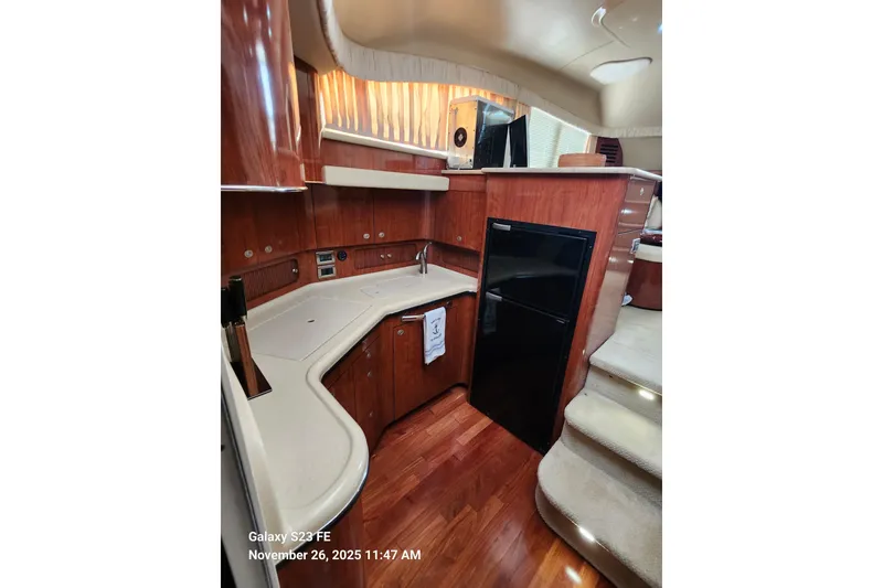 Slide: The Image of Interior of 2004 Sea Ray 390 Motor Yacht with modern kitchen and wood finish. - 36