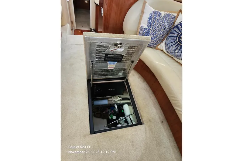 Slide: The Image of Open hatch in 2004 Sea Ray 390 Motor Yacht interior, revealing storage compartment. - 49