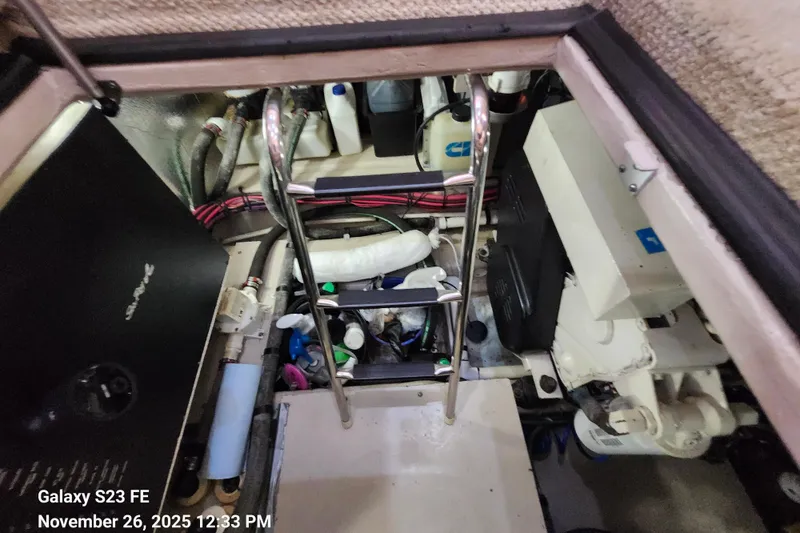 Slide: The Image of Engine compartment of a 2004 Sea Ray 390 Motor Yacht, showing various mechanical components. - 50