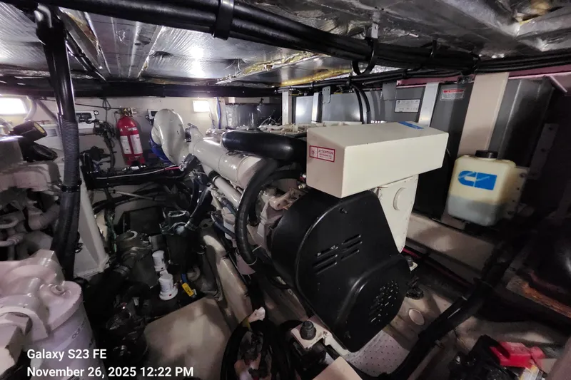 Slide: The Image of Engine room of 2004 Sea Ray 390 Motor Yacht, featuring mechanical components and fire extinguisher. - 51