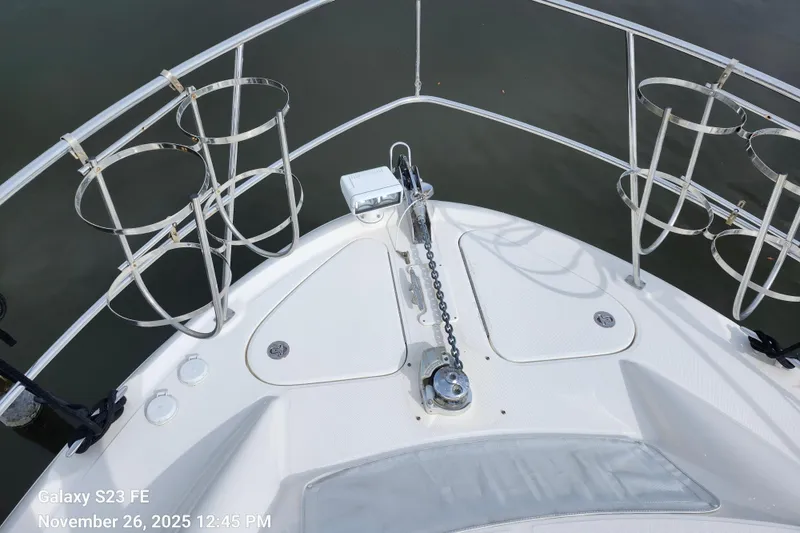 Slide: The Image of Bow of 2004 Sea Ray 390 Motor Yacht with anchor chain, fender racks, remote control spotlight, and railings. - 57