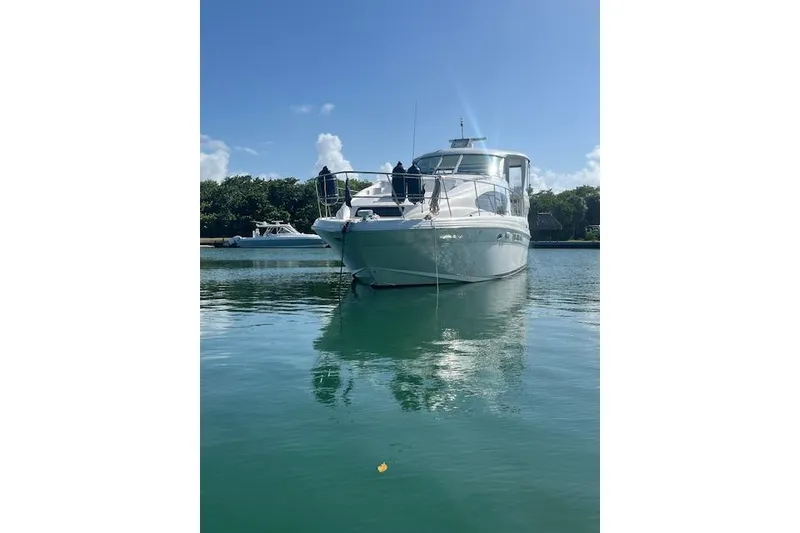Slide: The Image of 2004 Sea Ray 390 Motor Yacht on calm water under clear blue sky. - 58