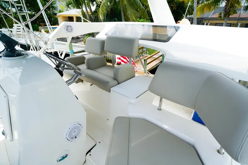 Slide: The Image of 2002 Silverton 352 Motor Yacht helm with gray seating and steering wheel. - 18