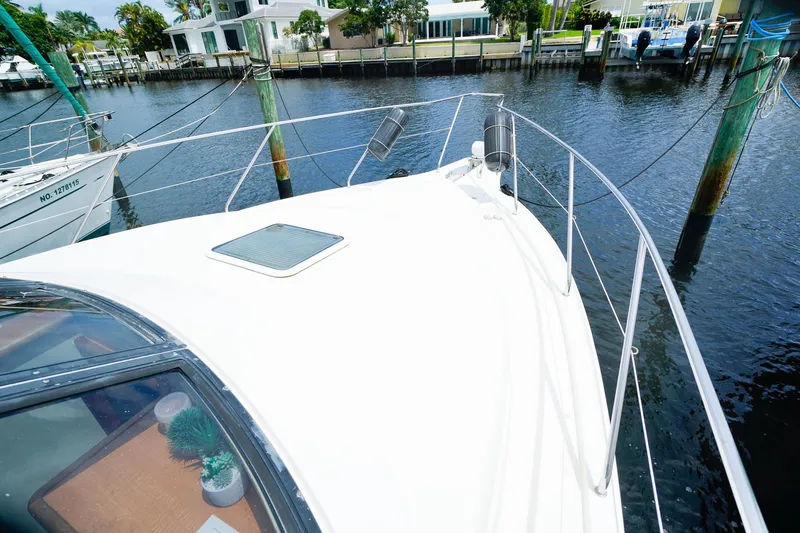 Slide: The Image of 2002 Silverton 352 Motor Yacht docked in a marina, showcasing sleek deck design. - 22