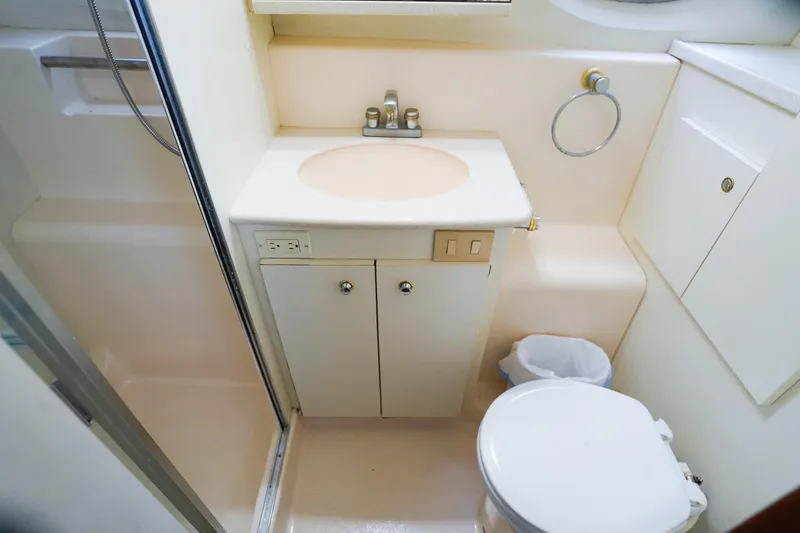 Slide: The Image of 2002 Silverton 352 Motor Yacht bathroom with sink, toilet, and shower area. - 29