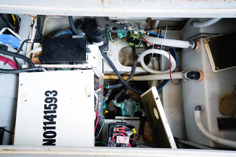 Slide: The Image of Engine compartment of a 2002 Silverton 352 Motor Yacht with visible wiring and components. - 46