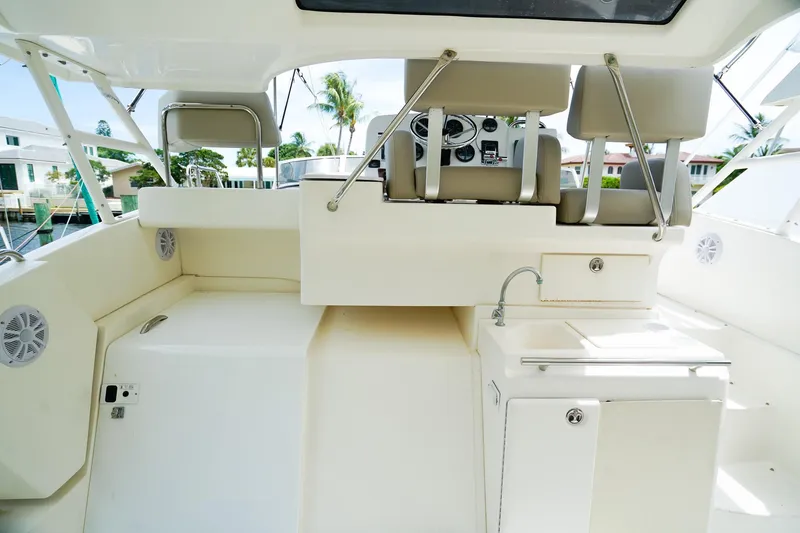 Slide: The Image of 2002 Silverton 352 Motor Yacht interior with helm, seating, and sink. - 9