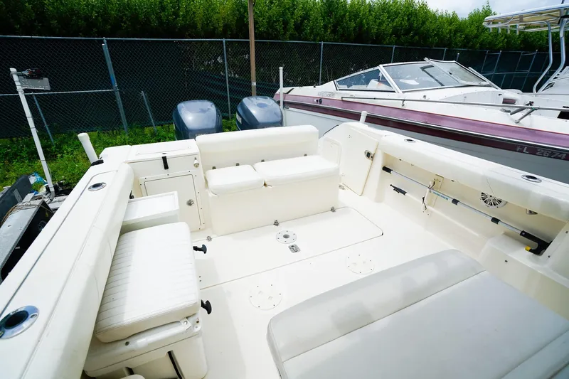 Slide: The Image of 2005 Pursuit 2670 Denali LS boat interior with seating and fishing rod holders. - 10