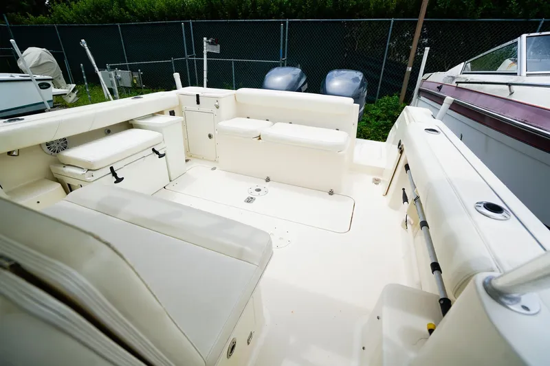 Slide: The Image of 2005 Pursuit 2670 Denali LS boat interior with spacious seating and storage. - 13