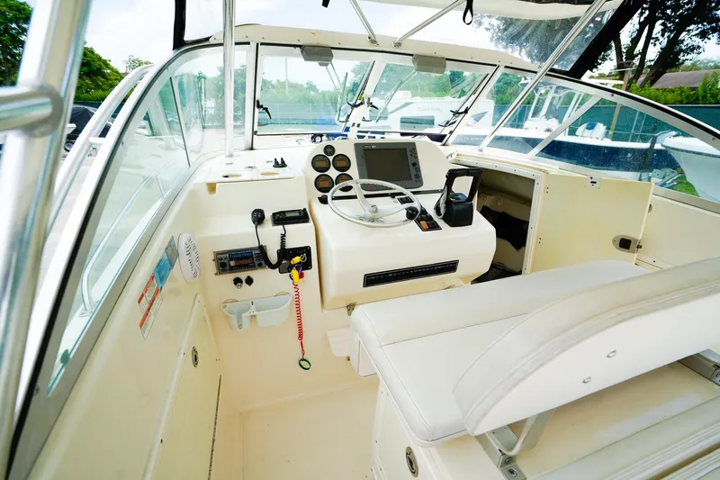 Slide: The Image of 2005 Pursuit 2670 Denali LS boat cockpit with steering wheel and control panel. - 14