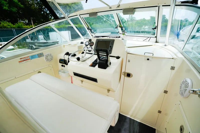 Slide: The Image of 2005 Pursuit 2670 Denali LS boat interior with steering wheel and navigation equipment. - 17