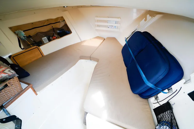 Slide: The Image of Interior cabin of 2005 Pursuit 2670 Denali LS boat with cushions and storage. - 18