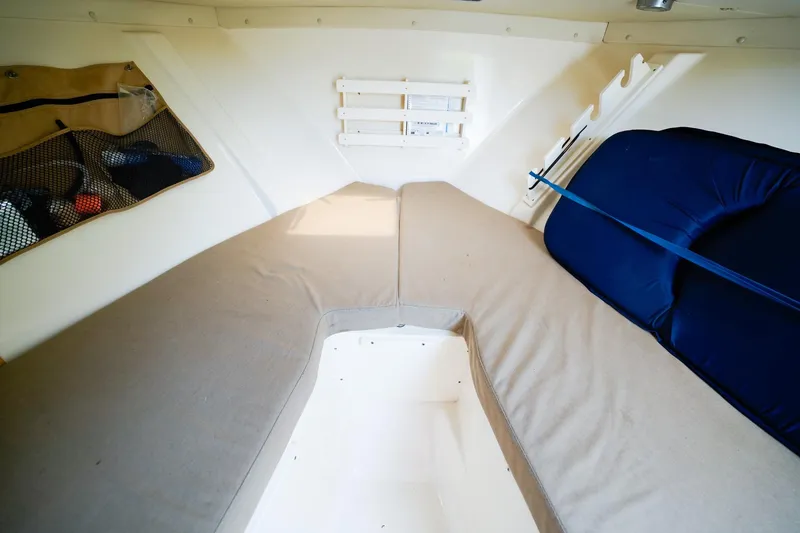 Slide: The Image of Interior cabin of 2005 Pursuit 2670 Denali LS boat with cushioned seating. - 19