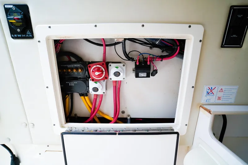 Slide: The Image of Electrical panel of a 2005 Pursuit 2670 Denali LS boat with wiring and switches. - 21