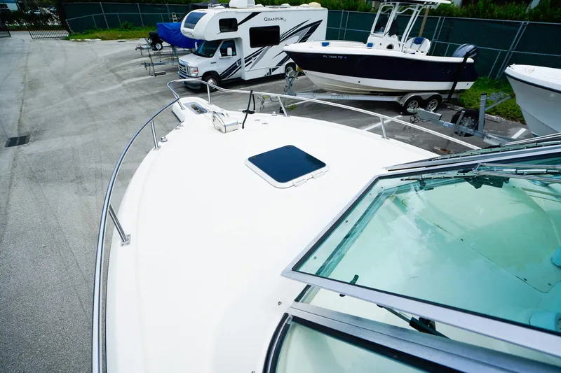 Slide: The Image of 2005 Pursuit 2670 Denali LS boat in storage yard with RV and trailer. - 23