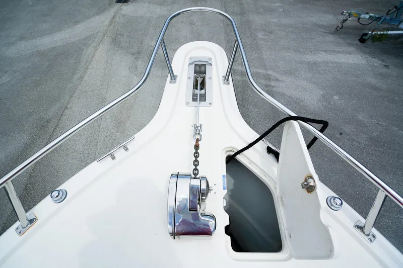 Slide: The Image of 2005 Pursuit 2670 Denali LS boat bow with anchor chain and open hatch. - 24