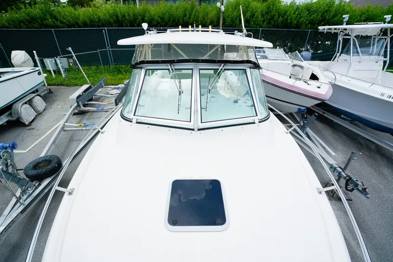Slide: The Image of 2005 Pursuit 2670 Denali LS boat on trailer, parked in a marina. - 26