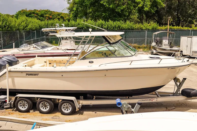 Slide: The Image of 2005 Pursuit 2670 Denali LS boat on trailer in marina setting. - 3