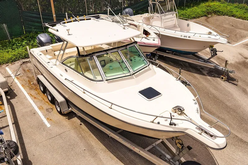 Slide: The Image of 2005 Pursuit 2670 Denali LS boat on trailer in parking lot. - 30