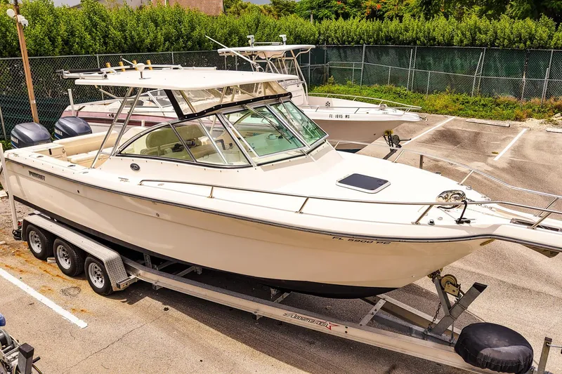 Slide: The Image of 2005 Pursuit 2670 Denali LS boat on trailer in parking lot. - 31