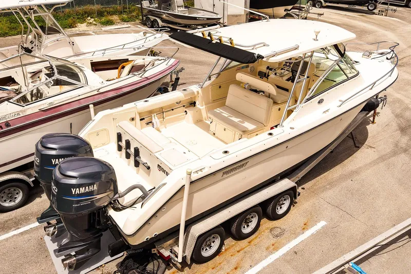 Slide: The Image of 2005 Pursuit 2670 Denali LS boat with twin Yamaha engines on a trailer. - 4