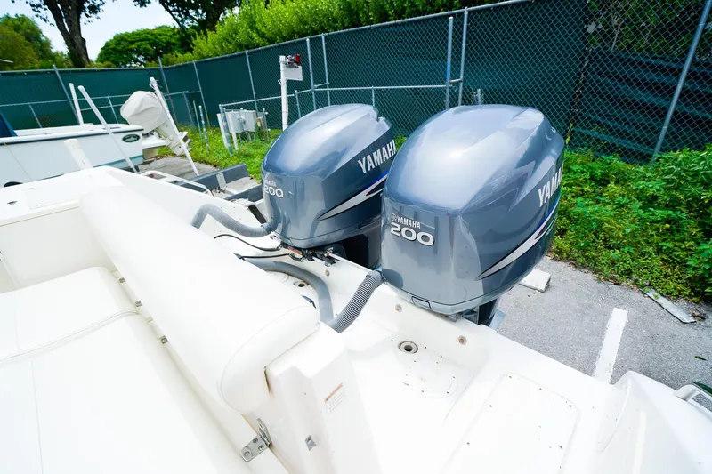 Slide: The Image of 2005 Pursuit 2670 Denali LS boat with twin Yamaha 200 engines, parked outdoors. - 7