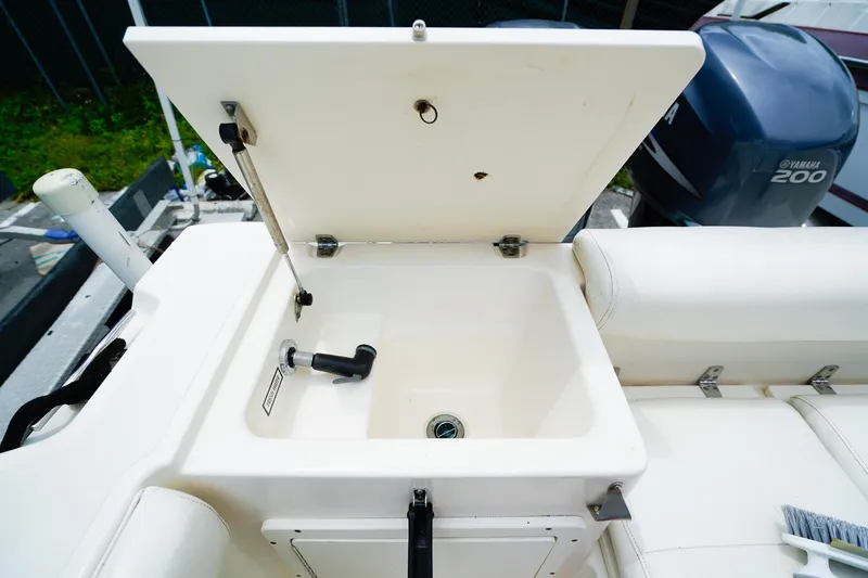 Slide: The Image of Open storage compartment on 2005 Pursuit 2670 Denali LS boat, featuring a Yamaha 200 engine. - 9