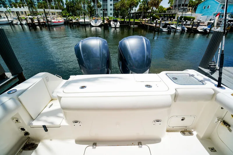 Slide: The Image of 2016 Sea Hunt Gamefish 30 boat docked near palm trees and waterfront homes. - 3