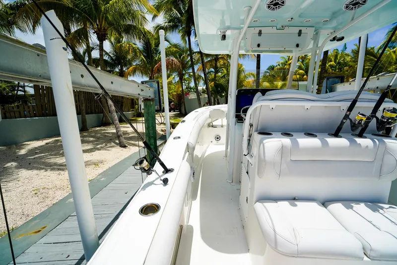 Slide: The Image of 2016 Sea Hunt Gamefish 30 boat interior with cushioned seating and fishing rod holders. - 7