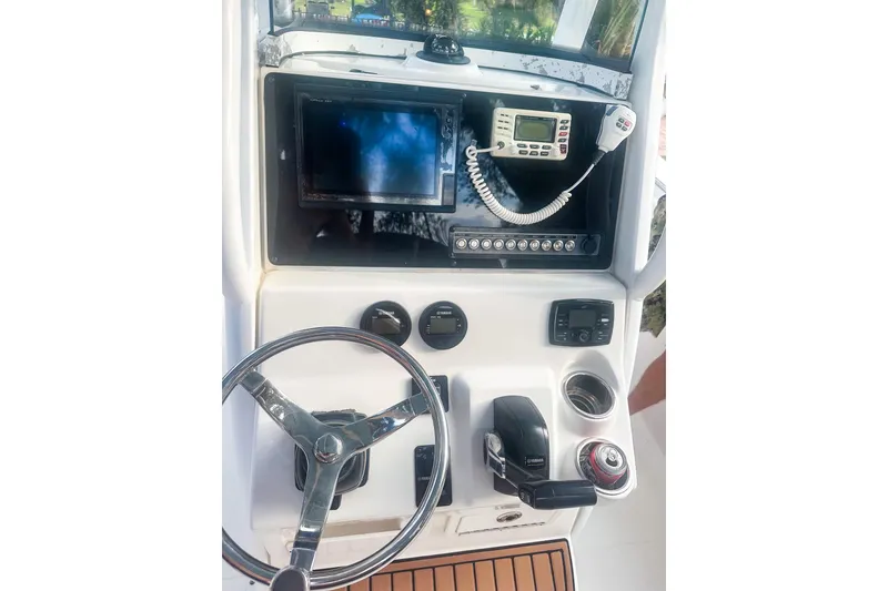 Slide: The Image of 2017 Tidewater 230 CC Adventure boat console with steering wheel, controls, and navigation equipment. - 10