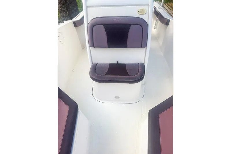 Slide: The Image of 2017 Tidewater 230 CC Adventure boat interior with cushioned seating. - 13