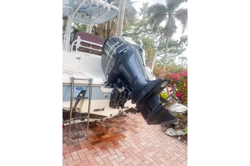 Slide: The Image of 2017 Tidewater 230 CC Adventure boat with Yamaha outboard motor, parked on brick driveway. - 5