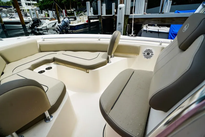Slide: The Image of 2022 Key West 219 FS boat interior with cushioned seating and cup holders. - 18
