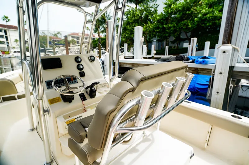 Slide: The Image of 2022 Key West 219 FS boat interior with steering console and rod holders. - 9