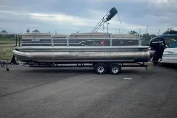 Slide: The Image of 2015 Sun Tracker Party Barge 24 XP3 pontoon boat on trailer, parked outdoors. - 11