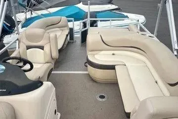 Slide: The Image of 2015 Sun Tracker Party Barge 24 XP3 with beige seating and spacious deck layout. - 8