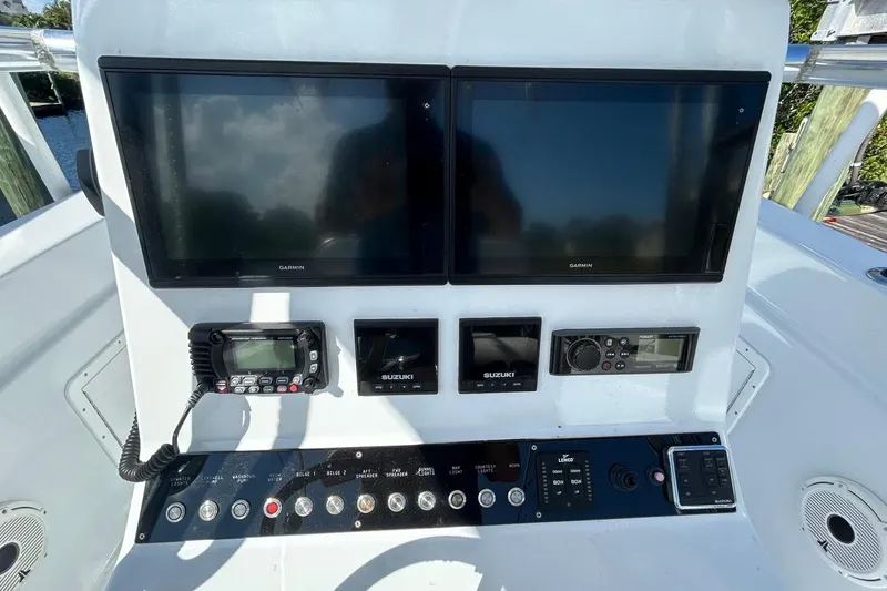 Slide: The Image of 2006 Whitewater 28 boat dashboard with dual Garmin screens and control panel. - 10