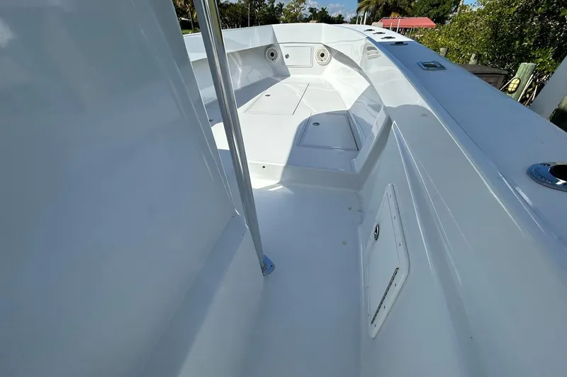 Slide: The Image of 2006 Whitewater 28 boat deck, sleek design, sunny day, surrounded by water and palm trees. - 12